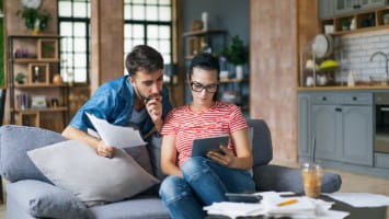 Young couple reviewing paperwork together.