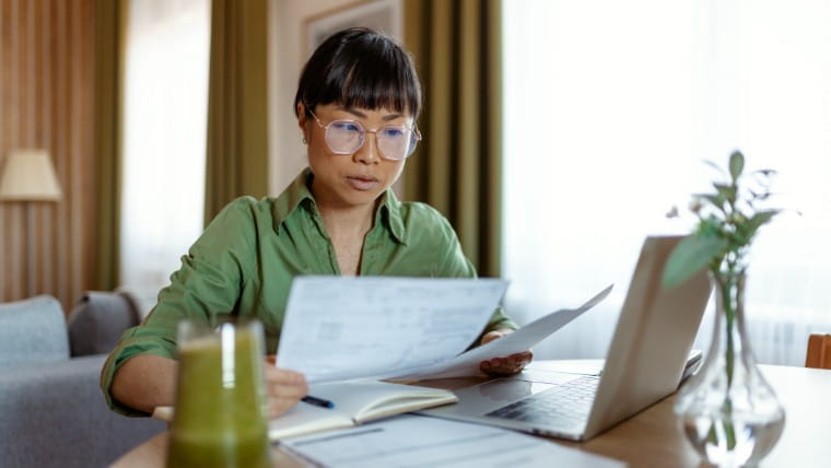 Professional woman reviewing financial documents.
