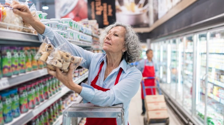 Senior woman working in grocery store.