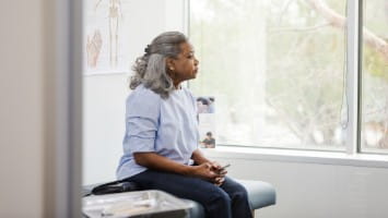 Senior woman waits in doctor's office.