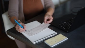 Woman writing a personal check.