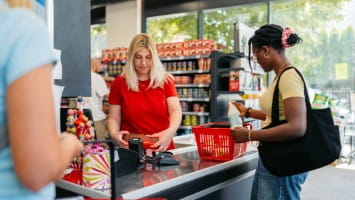 Employee rings up customer at register.