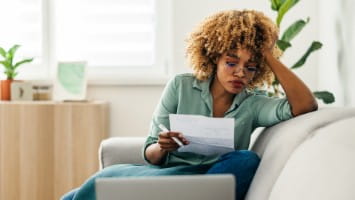 Young woman reviewing a bill.