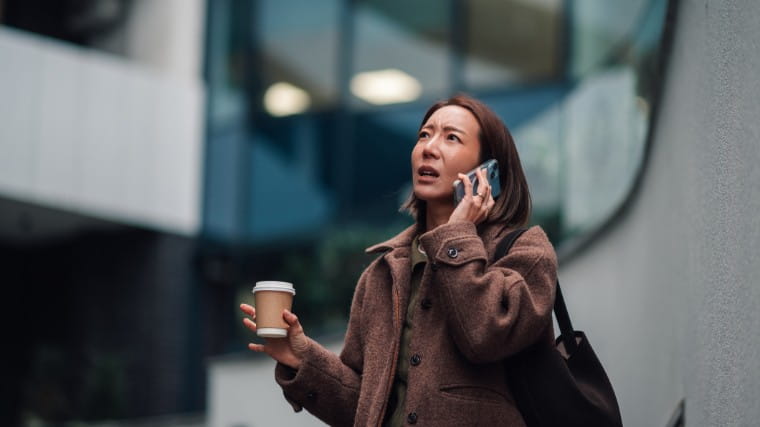 Woman on phone call looking worried.