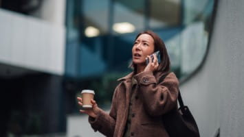 Woman on phone call looking worried.