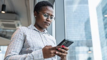 Concerned woman reading something on her phone.