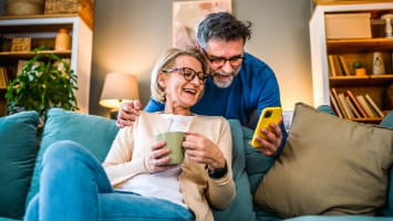 Senior couple looking at smartphone together.