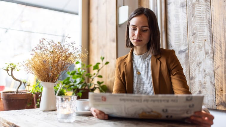 Woman reading the newspaper.