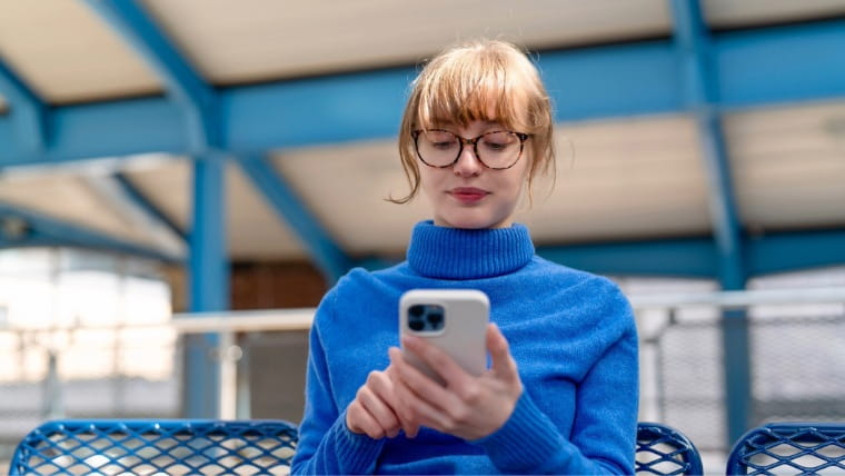 Young woman looking at cellphone.