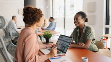 Woman working with bank teller.