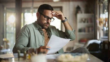 Unhappy man reading document.