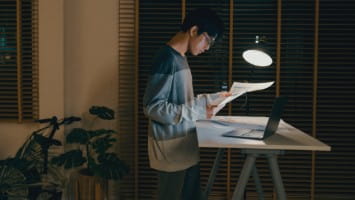 Young man reviewing financial paperwork.