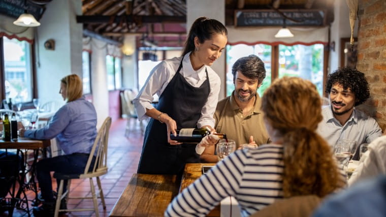 Waitress serving table of customers.
