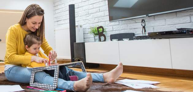 caretaker and child coloring together