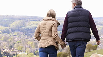  A couple enjoying a countryside walk with their dog