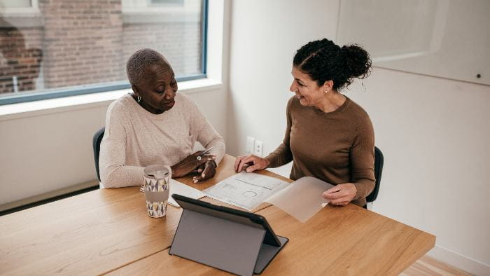 Woman working with financial counselor.