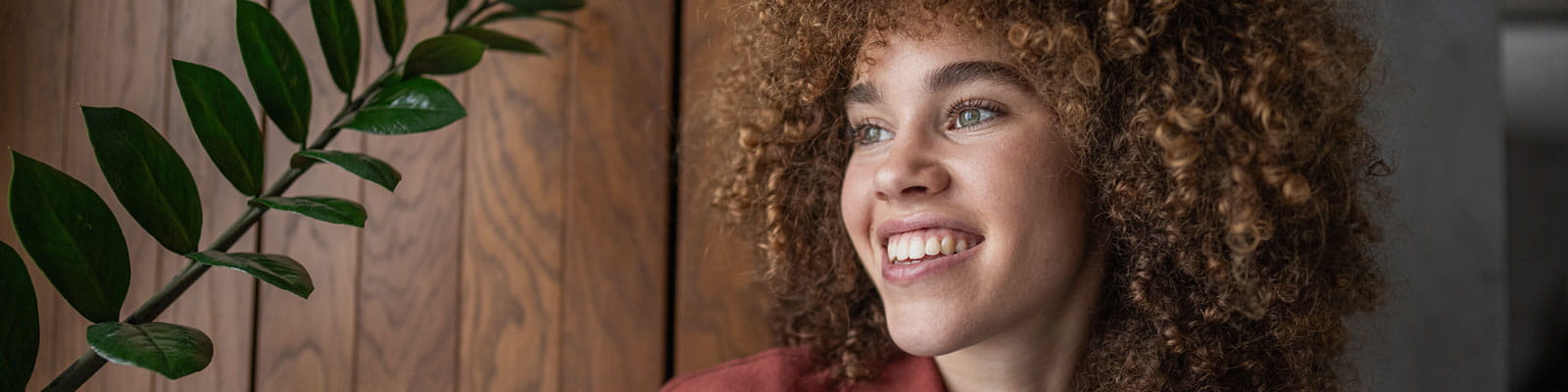 Curly-haired female smiling