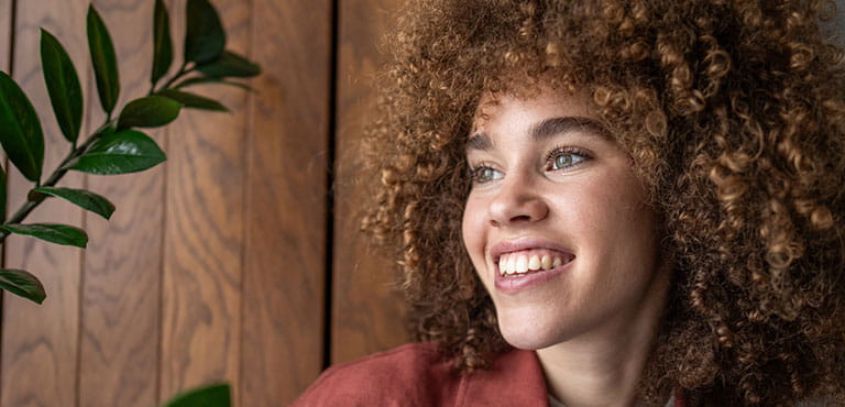 Curly-haired female smiling