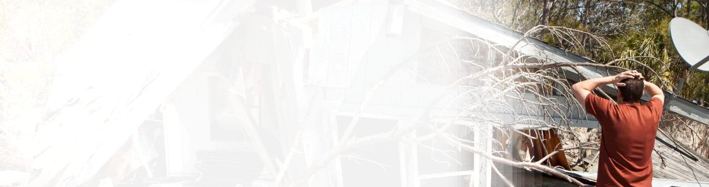 man assessing damage to his home