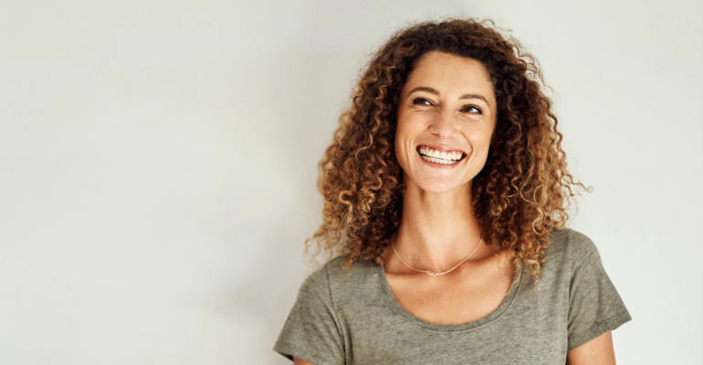 Smiling woman in front of white background