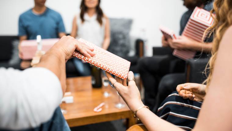 A group of friends sharing Christmas gifts