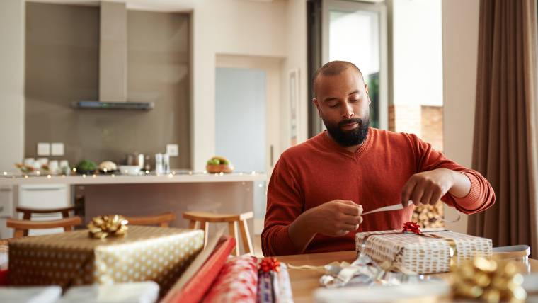 man wrapping presents