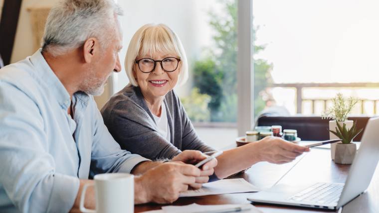 Retirement aged couple discussing their finances.