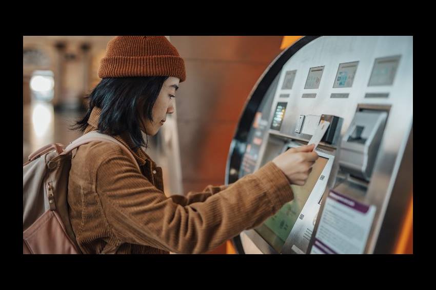 woman looking into empty wallet