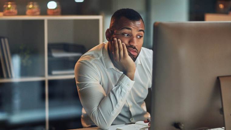 man staring at computer, feeling down