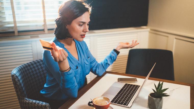 Unhappy woman trying to pay for something online.