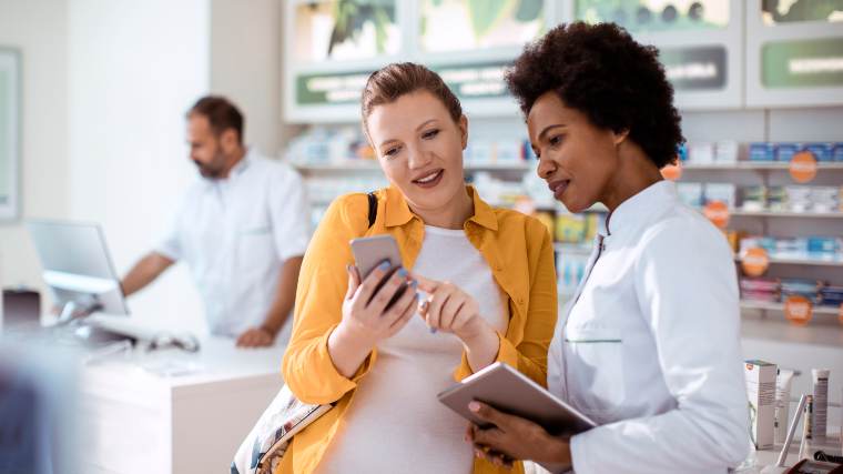 Woman talking to a pharmacist.