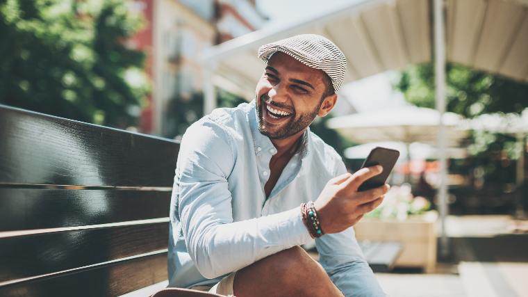 Happy man with cellphone.