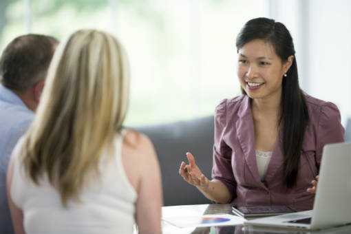 Female credit counselor helping a couple with their finances