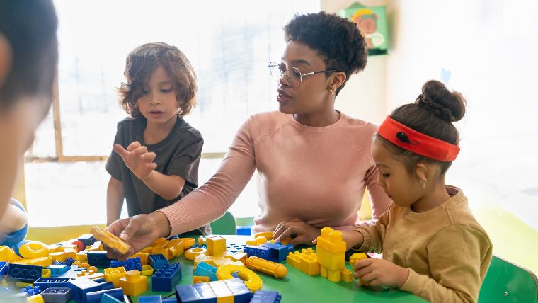 Small children and caregiver in a daycare facility.