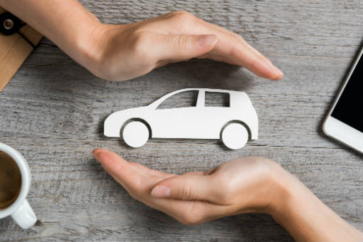 Figure of car between two hands