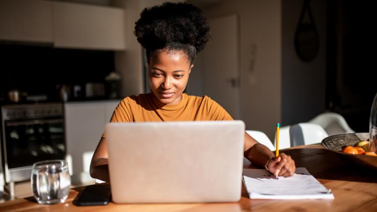 Woman reviewing her credit report on her laptop.