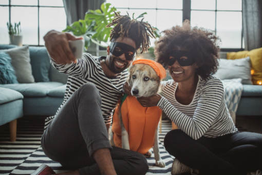 Couple and dog dressed for Halloween