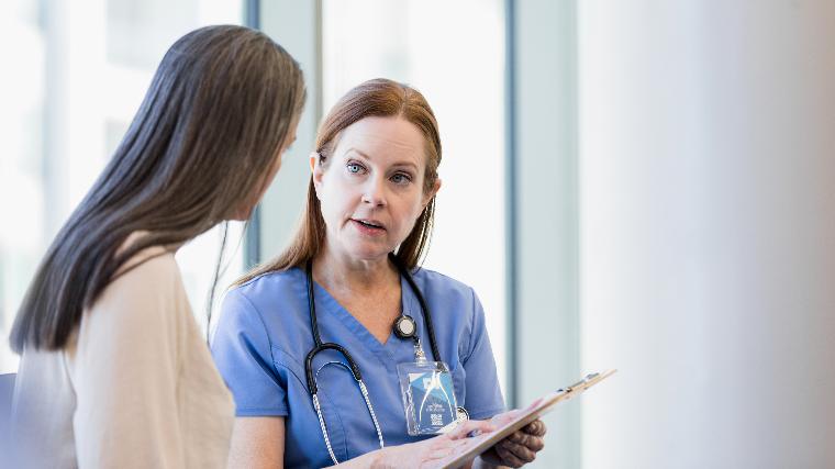 Patient speaking with nurse.