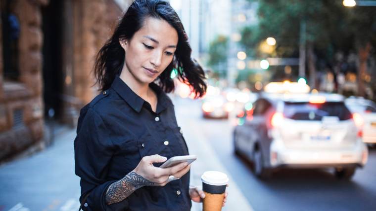 Woman reviewing financial apps on her smartphone.