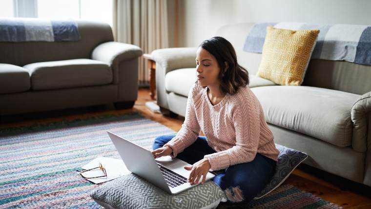 Woman reviewing her credit report on her laptop.