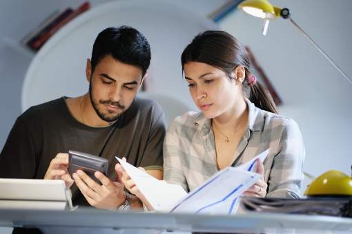 Hispanic couple reviewing their finances