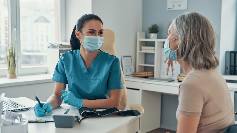 Nurse speaking to a patient.