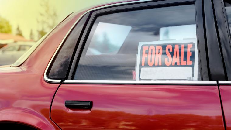 Car with for sale sign in the side window.