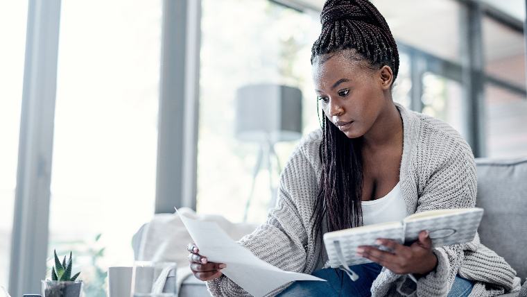 Woman reading financial documents.