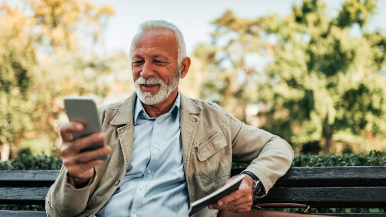 elderly man checking his phone