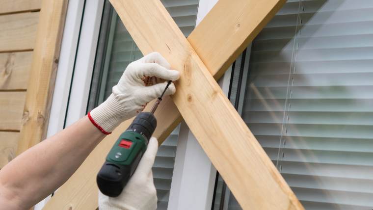 nailing boards across a window