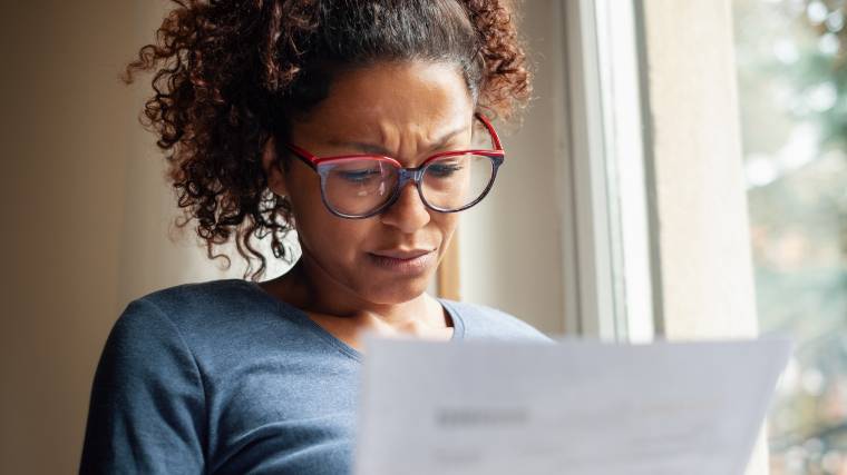woman reading a document and seemingly feeling confused