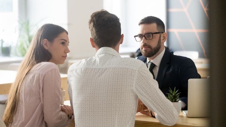 Couple consulting with a lawyer.