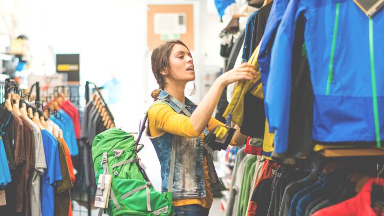 woman comparing items in a clothing store