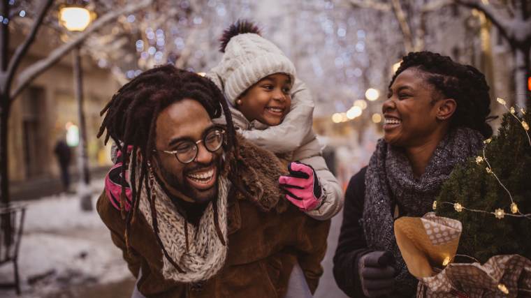 young family outside during the holidays